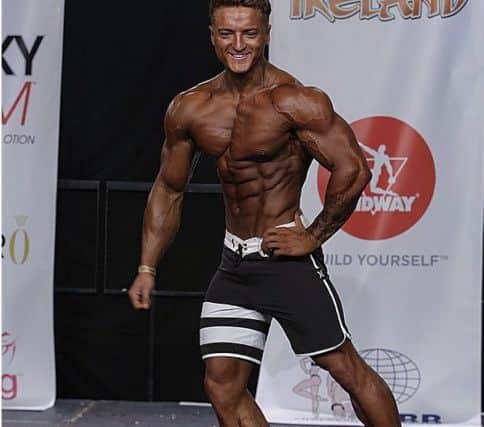 Josh Coyle on stage at the International Federation of BodyBuilding and Fitness Muscle Contest Ireland event in Limerick where he was the overall winner in the Men's Physique competition.