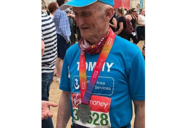 Tommy Fee proudly wearing the medal he received for completing the 2018 London Marathon.