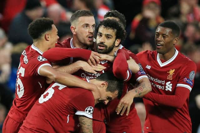 Liverpool's Mohamed Salah is mobbed by his team-mates after scoring his side's first goal of the game during the UEFA Champions League semi-final against Roma