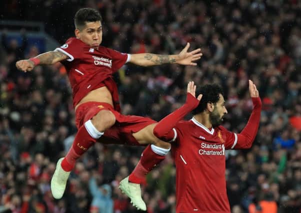 Liverpool's Mohamed Salah (right) celebrates with Roberto Firmino after scoring his side's second goal of the game in Tuesday night's 5-2 win over Roma
