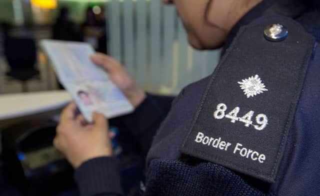 A Border Force officer checking a passport. The Home Office has said its requirement for a British passport for Border Force jobs was an error