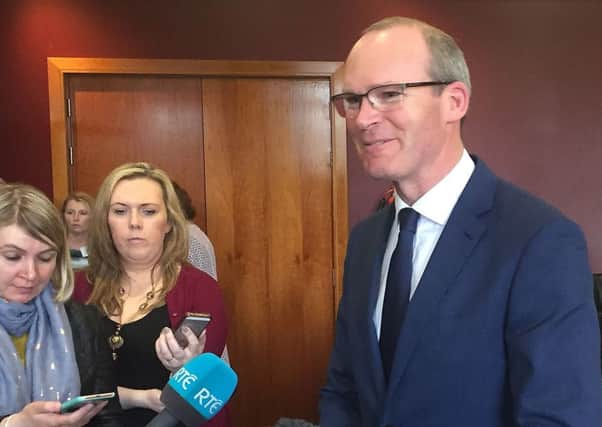 Simon Coveney talks to the press during his visit to Londonderry for a lunch with business leaders