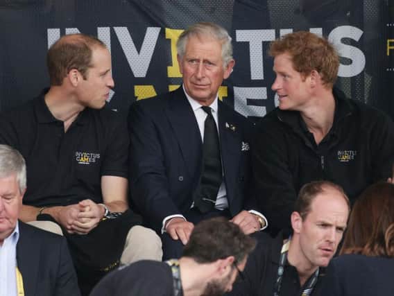 File photo dated 11/9/2014 of the Duke of Cambridge, Prince Charles and Prince Harry during day two of the Invictus Games Athletics competition, at Lee Valley Athletics Centre, London. Prince Harry has asked his brother the Duke of Cambridge to be his best man at his wedding to Meghan Markle, Kensington Palace said
