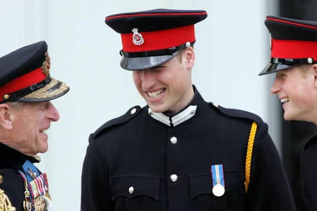 File photo dated 12/4/2006 of the Duke of Edinburgh speaking to Prince William and Prince Harry at Sandhurst Royal Military Academy after The Sovereign's Parade that marked the completion of Prince Harry's Officer training. Prince Harry has asked his brother the Duke of Cambridge to be his best man at his wedding to Meghan Markle, Kensington Palace said.