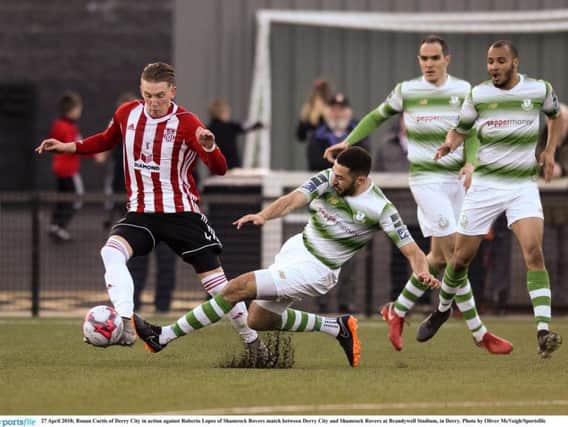 Roberto Lopes slides in on Derry City attacker, Ronan Curtis who later had to be substituted following a head injury.