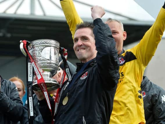 Crusaders manager Stephen Baxter celebrates with the Gibson Cup.