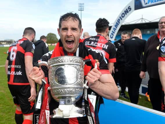 Crusaders' Sean Ward celebrates with the Gibson Cup.