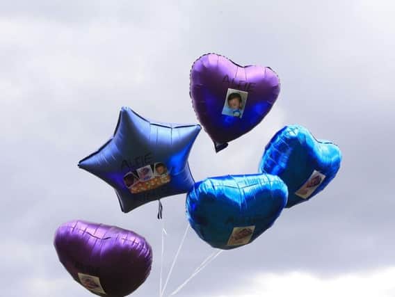 People gather to release balloons outside Alder Hey Children's Hospital in Liverpool, following the death on Saturday morning of 23-month-old Alfie Evans