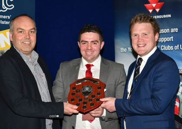 Clarence Calderwood, United Feeds presents Andrew Patton with an award for YFCU senior member of the year, with James Speers, YFCU president