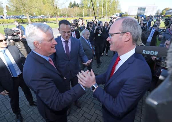 Ireland's Foreign Affairs Minister Simon Coveney (right) greets the EU's chief Brexit negotiator Michel Barnier as they arrive at the All-Island Civic Dialogue conference on Brexit, at the Dundalk Institute of Technology.  Photo credit: Niall Carson/PA Wire