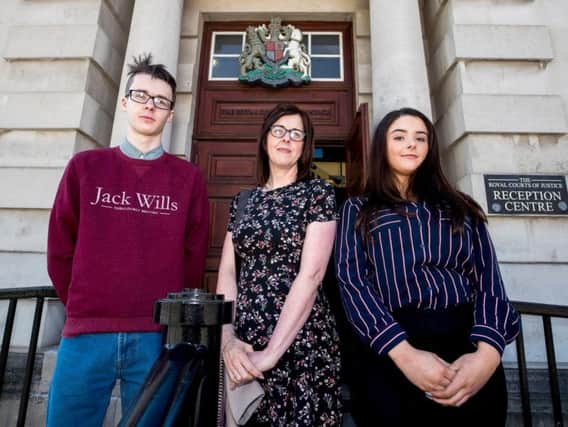Siobhan McLaughlin (centre) and her children Billy and Rebecca Adams, as the trio arrive at the Royal Courts of Justice in Belfast, where McLaughlin is fighting a legal battle for access to benefits and allowances granted to widows