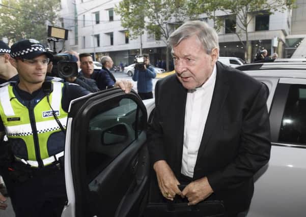 Australian Cardinal George Pell arrives at the Magistrates Court in Melbourne, Australia, Tuesday, May 1, 2018. Pell, the most senior Vatican official to be charged in the Catholic Church sex abuse crisis, arrived surrounded by police and media to learn whether he must stand trial on charges that he sexually abused multiple victims decades ago. (Joe Castro/AAP Image via AP)