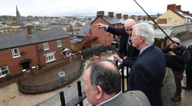 The EU's chief Brexit negotiator Michel Barnier (right) is shown the scene of the Bloody Sunday massacre, during his a walkabout in Londonderry