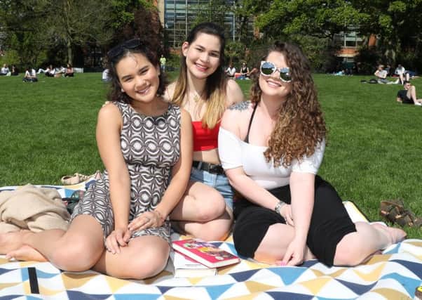 Rheagh Goh and Marie Philips, both from Malaysia, and Kendall Hall from Cambridge enjoy the good weather in Botanic Gardens, Belfast on Sunday