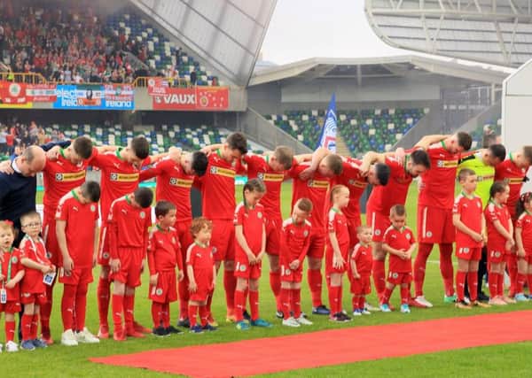 Cliftonville players bow their heads while the national anthem was played before the 2018 cup final on Saturday.  Photo by David Maginnis/Pacemaker Press