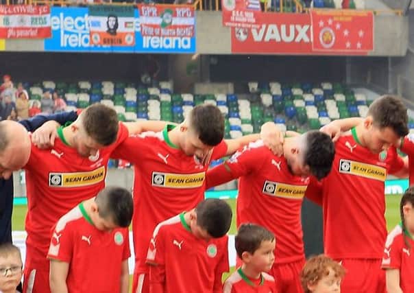 Cliftonville's players bow their heads during the playing of the national anthem before Saturday's game at the National Stadium, Belfast.  Photo by David Maginnis/Pacemaker Press