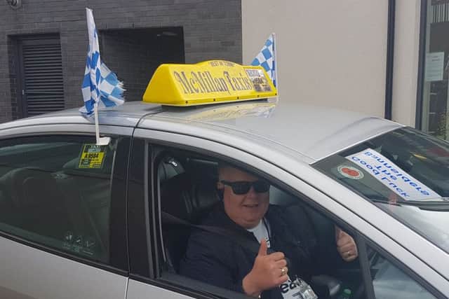 Taxi driver Kenny McMillan has decorated his car with blue and white flags