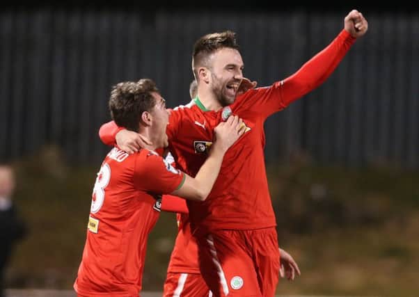 Jamie Harney celebrates scoring three against Warrenpoint Town