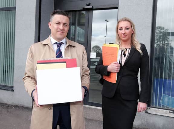 John Greer and Lisa Graham of Reavey and Company Solicitors handing in documents to the coroner's services in Belfast which claim a UVF sniper was involved in the 1971 Ballymurphy shooting    Picture by Jonathan Porter/PressEye