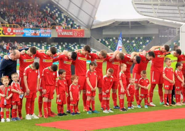 The Cliftonville players bow their heads as the national anthem is played before Saturdays Irish Cup final