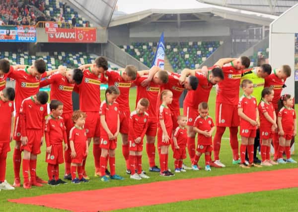 Cliftonville's players bow their heads during the playing of the national anthem before Saturday's game at the National Stadium Windsor Park Belfast.  Photo: David Maginnis/Pacemaker Press