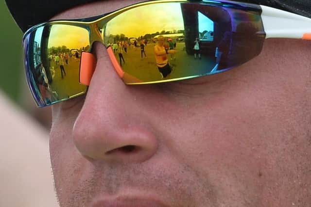 Runners reflected in sunglasses