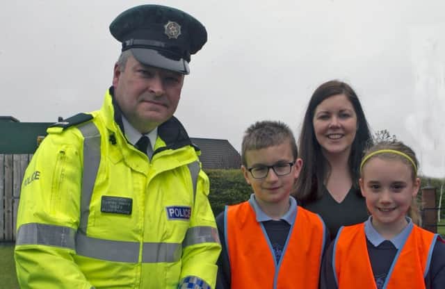 Const Sydney Henry, PSNI Road Safety, who gave a talk on cycling safety at Fourtowns PS, Ahoghill, with pupils Jack and Skye and principal Mrs Parker.