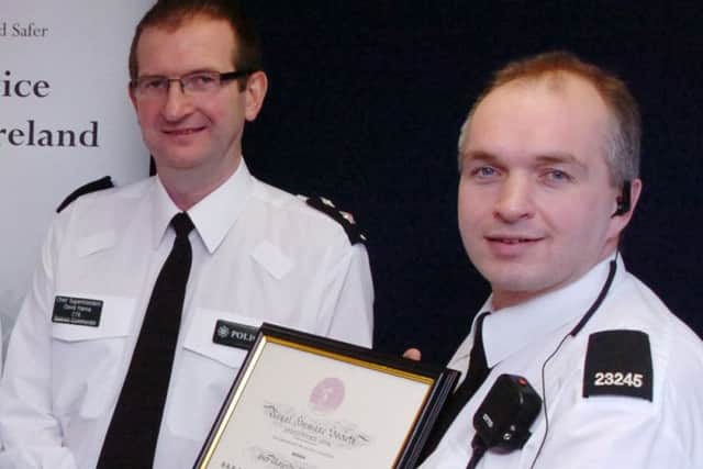 Stephen Heaney (right) receives a Royal Humane Society award for bravery from Chief Superintendent David Hanna