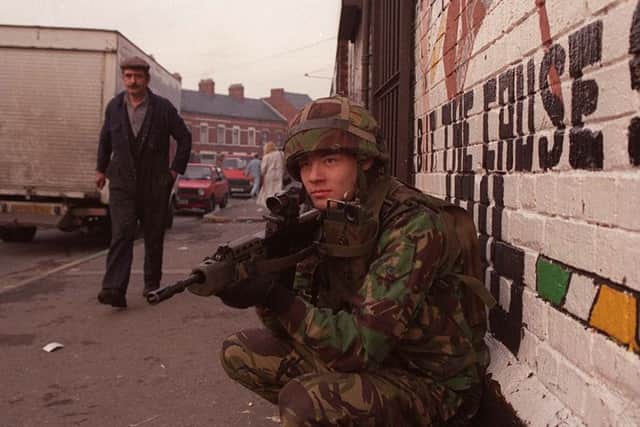 A soldier on patrol in Belfast in the 1990s. A number of former troops have been charged over alleged involvement in fatal incidents during the Troubles