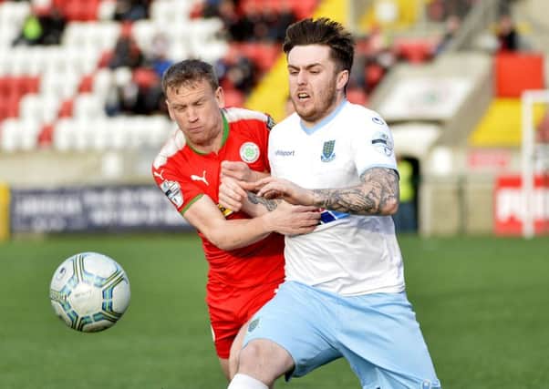 Cliftonville's Liam Bagnall in action with Ballymena's Cathair Friel