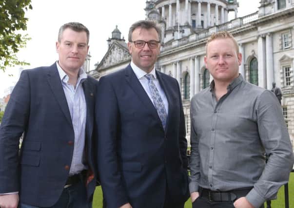 Invest NI chief executive Alastair Hamilton, centre, with Teamwork chief executive Peter Coppinger, right, and chief techincal officer Daniel Mackey at the jobs announcement in Belfast
