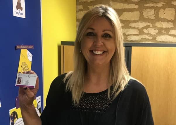 Lisa Turan, CEO of the Child Brain Injury Trust, with one of the new Brain Injury Information Cards.