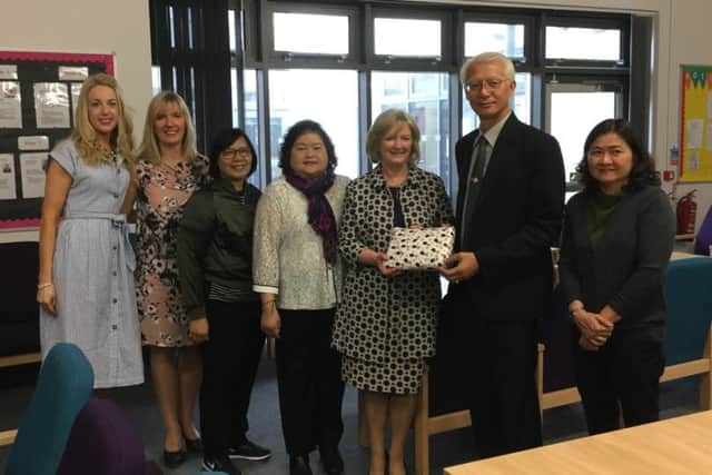 Mr Suthi Jantarawong, on behalf of the Thai officials, presents a gift to Principal Linda Allen and her colleagues to thank them for their warm welcome to Dromore Central Primary School.