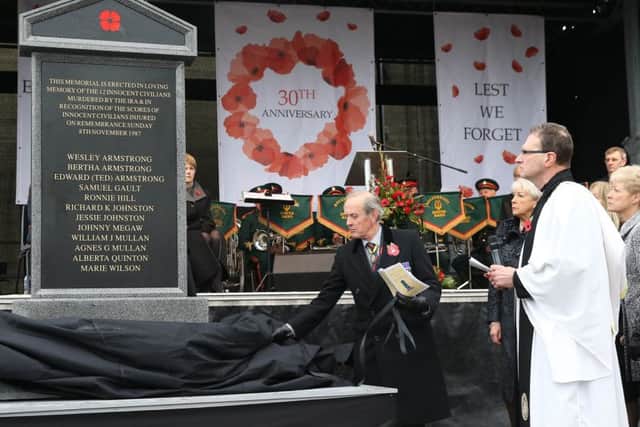 Rev Kenneth R J Hall and Viscount Brookeborough unveil the memorial in Enniskillen for the victims of the 1987 Poppy Day Bomb on the 30th anniversary of the atrocity, 8 Novemeber 2017. Although unveiled on the bomb site, the memorial had to be removed and put into storage after the event as the Catholic church said it had not been consulted about locating it there.