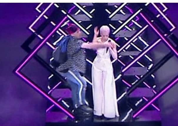 The moment when the stage invader interrupted SuRie's performance on Saturday night
