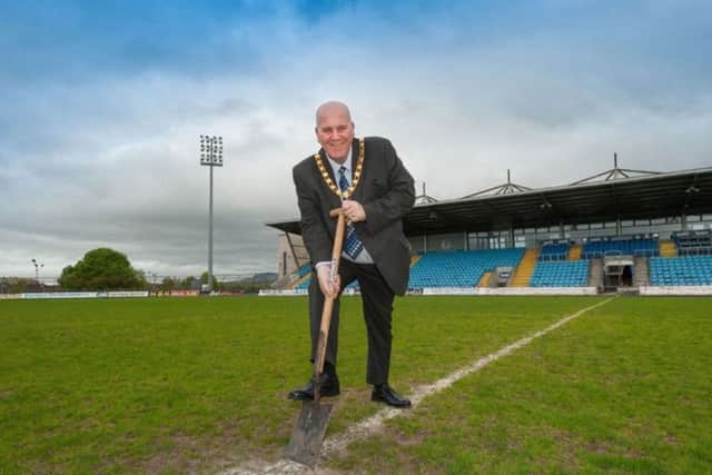 The Mayor of Mid and East Antrim, Cllr Paul Reid, cutting a sod of turf at Ballymena Showgrounds as part of his charity appeal.
