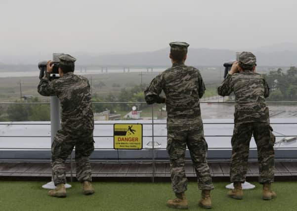 South Korean marine force members look toward North's side through binoculars at the Imjingak Pavilion in Paju near the border village of Panmunjom, South Korea, today, Wednesday, May 16, 2018. North Korea on Wednesday cancelled a meeting with South Korea and threatened to scrap a summit next month between Presidents Donald Trump and Kim Jong Un. (AP Photo/Ahn Young-joon)