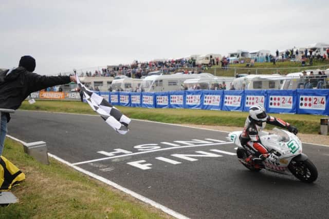 Michael Dunlop crosses the line to win the 250cc race at the North West 200 in 2008. His father, Robert, was killed in practice for the race less than 48 hours earlier.