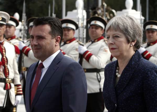 Theresa May is welcomed by her Macedonian counterpart Zoran Zaev in Macedonia following a visit to Bulgaria
