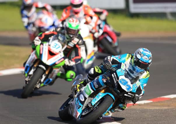 Alastair Seeley on his way to victory in the Supersport race from James Hillier and Lee Johnston.