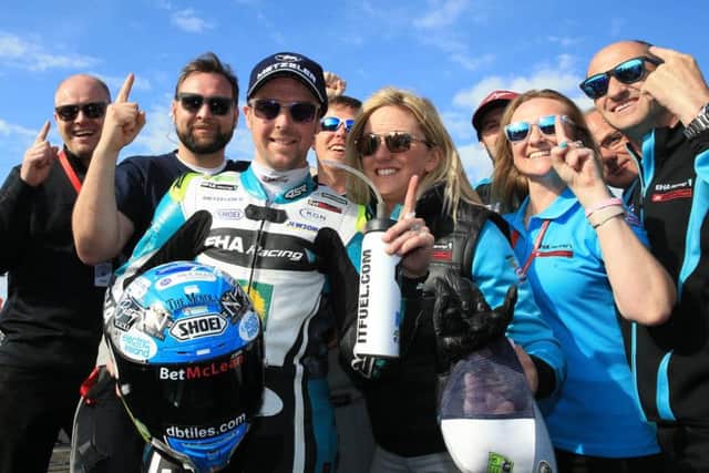 Carrick's Alastair Seeley celebrates with the EHA Racing team after his 11th Supersport win at the North West 200.