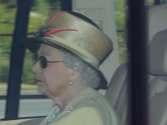Queen Elizabeth II is driven into Windsor Castle in a Range Rover the day after the royal wedding