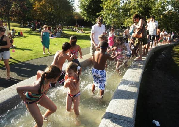 Visitors make the most of the hot weather at the Diana, Princess of Wales Memorial Fountain, in Hyde Park, central London, during a heatwave in 2011