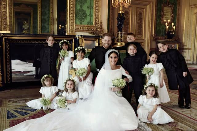 This official wedding photograph released by the Duke and Duchess of Sussex shows The Duke and Duchess in The Green Drawing Room, Windsor Castle, with (left-to-right): Back row: Master Brian Mulroney, Miss Remi Litt, Miss Rylan Litt, Master Jasper Dyer, Prince George, Miss Ivy Mulroney, Master John Mulroney. Front row: Miss Zalie Warren, Princess Charlotte, Miss Florence van Cutsem.