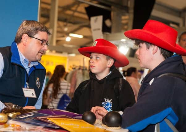 Jonathan Mattison speaks with young visitors to the Orange Order stand at the Balmoral Show