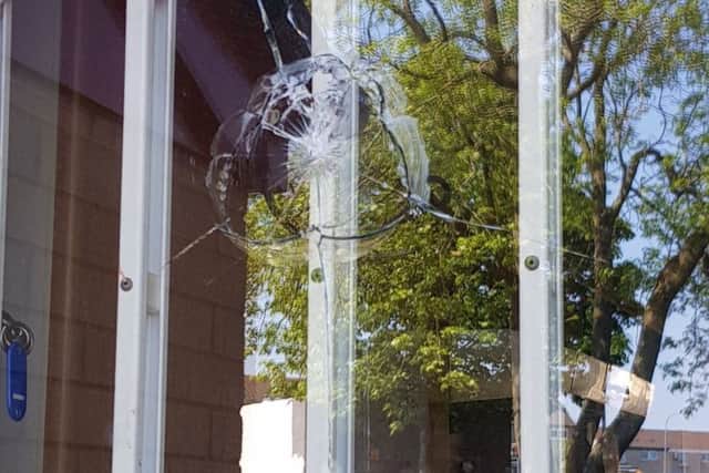 Glass broken with what appears to be a shot from a pellet gun at the Community House in Drumbeg