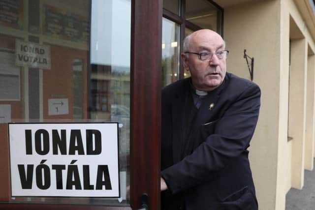 Father Tom Harrington arrives at the polling station in Knock National school, Mayo, as the country goes to the polls to vote in the referendum on the 8th Amendment of the Irish Constitution.