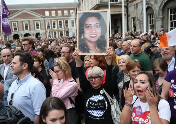 A supporter holds a photo of Savita Halappanavar in Dublin Castle as campaigners celebrate the repeal the Eighth Amendment of the Irish Constitution