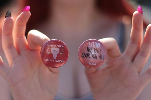 A woman sells badges at Belfast City Hall yesterday during a People Before Profit protest calling for provision of abortion in Northern Ireland