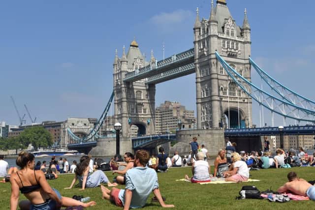 People enjoy the hot weather at Potters Field Park, London, as Britons could see the hottest day of the year this Bank Holiday Monday. Photo: John Stillwell/PA Wire